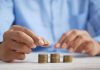 a man puts coins in piles