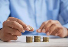 a man puts coins in piles