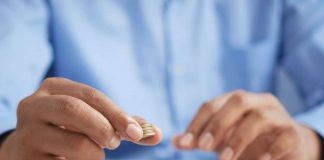 a man puts coins in piles