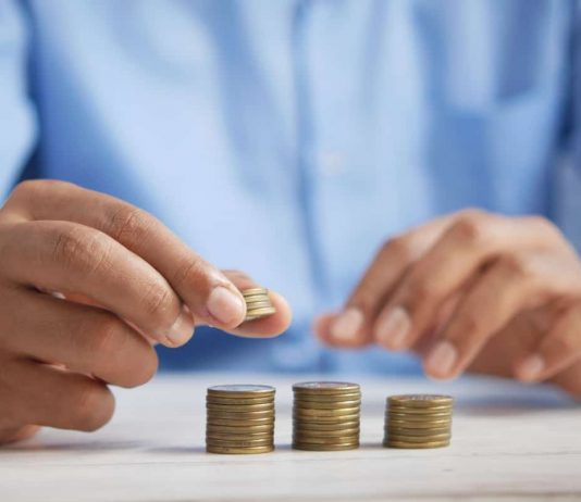 a man puts coins in piles