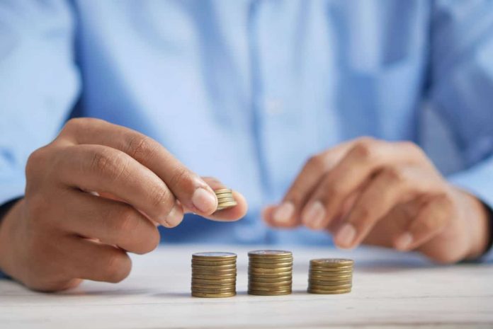 a man puts coins in piles